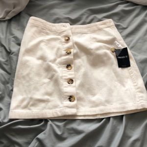 Cream colored mini button-up skirt